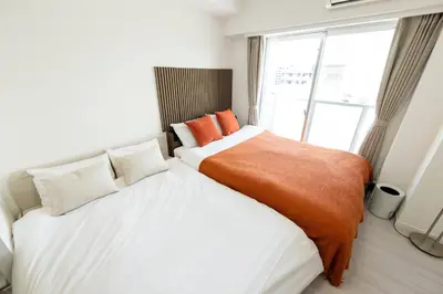 a bedroom with two beds and a window at LIVCITY Kinshicho 1201 Skytree view in Tokyo