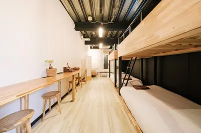 a room with bunk beds and a desk at Blossom House Shibuya in Tokyo