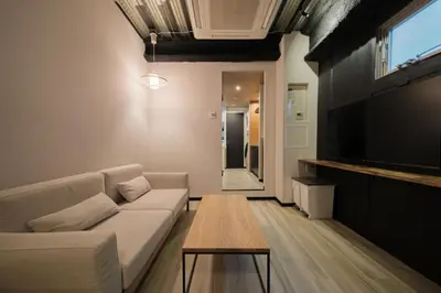 a living room with a couch and a table at Blossom House Shibuya in Tokyo