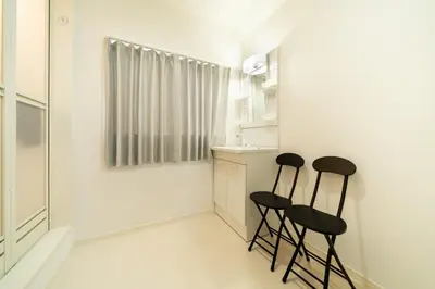 two black stools in a white kitchen with a counter at 107, Takasago A,,Entire house for rent \u9ad8\u7802A in Tokyo