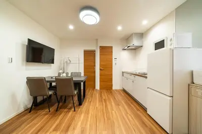 a kitchen and dining room with a table and a refrigerator at 107, Takasago A,,Entire house for rent \u9ad8\u7802A in Tokyo