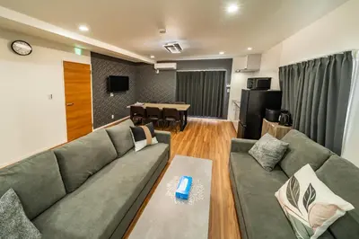 a living room with a couch and a table at 107, Takasago A,,Entire house for rent \u9ad8\u7802A in Tokyo
