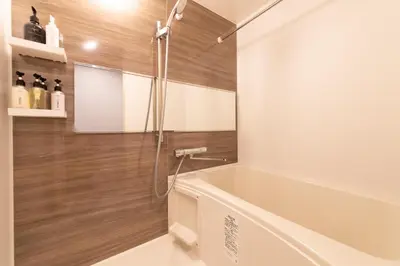 a bathroom with a tub and a shower at SLEEPLAB THE STAY Casual \u6c60\u888b -Ikebukuro- in Tokyo