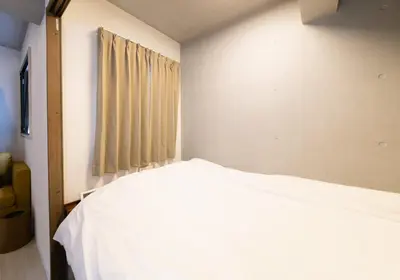 a bedroom with a bed and a window at SLEEPLAB THE STAY Casual \u6c60\u888b -Ikebukuro- in Tokyo