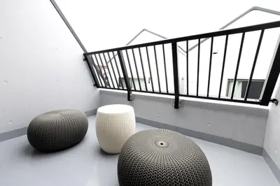a balcony with two vases on the floor of a building at SLEEPLAB THE STAY Casual \u6c60\u888b -Ikebukuro- in Tokyo