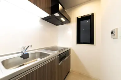 a small kitchen with a sink and a window at SLEEPLAB THE STAY Casual \u6c60\u888b -Ikebukuro- in Tokyo