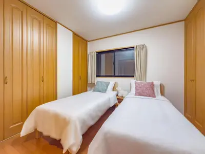 two beds in a room with a window at \u62bc\u4e0ahotel max4 people -SM0385 in Tokyo
