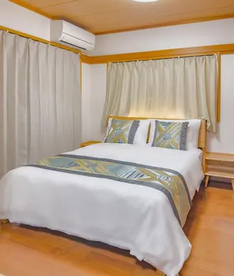 a bedroom with a large white bed and a window at \u62bc\u4e0ahotel max4 people -SM0385 in Tokyo