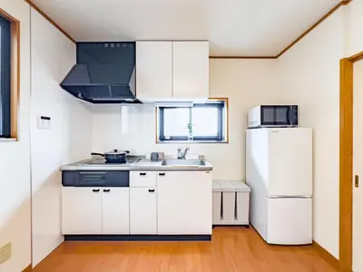 a kitchen with white cabinets and a refrigerator at \u62bc\u4e0ahotel max4 people -SM0385 in Tokyo