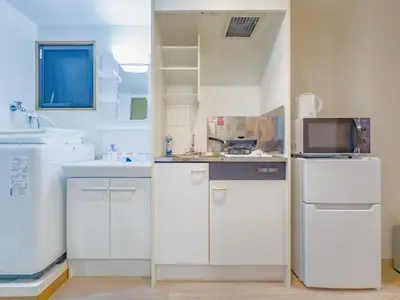 a white kitchen with a sink and a microwave at \u62bc\u4e0a hotel \u5927\u5e8a\u623f -SM0387 in Tokyo