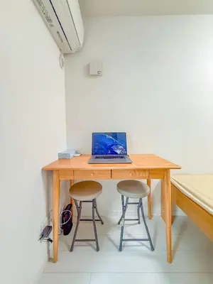 a wooden table with a laptop on it with two stools at \u79cb\u53f6\u539f hotel -TT0379 in Tokyo