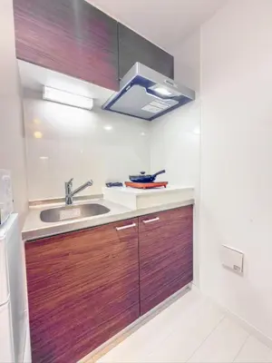 a kitchen with wooden cabinets and a sink at \u79cb\u53f6\u539f hotel -TT0379 in Tokyo