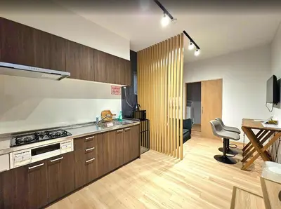 a kitchen with wooden cabinets and a sink and a desk at \u96f2\u820e\u65c5\u9928 in Tokyo