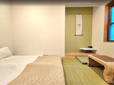 a bedroom with a large bed and a window at \u96f2\u820e\u65c5\u9928 in Tokyo