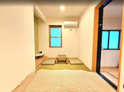 a room with two mats on the floor and a table at \u96f2\u820e\u65c5\u9928 in Tokyo