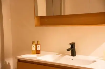 two bottles of wine sitting on a bathroom sink at \u96f2\u820e\u65c5\u9928 in Tokyo