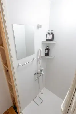 a bathroom with a white door with a mirror at CREA BASE -Indoor Glamping Retreat- in Tokyo