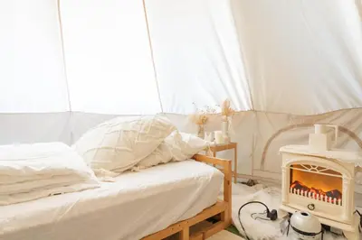 a bedroom with a bed and a wood stove at CREA BASE -Indoor Glamping Retreat- in Tokyo