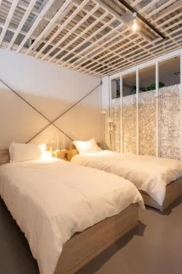 two beds sitting next to each other in a bedroom at CREA BASE -Indoor Glamping Retreat- in Tokyo