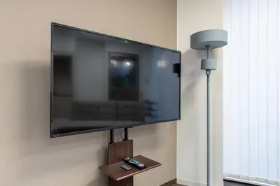 a flat screen tv hanging on a wall at \u5bcc\u4e45\u30b9\u30af\u30a8\u30a2 in Tokyo