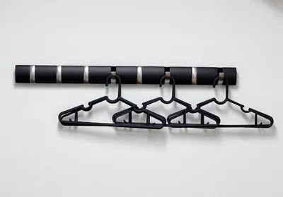 a black metal rack with four hooks on a wall at \u5bcc\u4e45\u30b9\u30af\u30a8\u30a2 in Tokyo