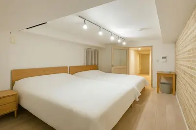a bedroom with a large white bed with lights above it at \u9526\u7cfb\u753a hotel -SM0380 in Tokyo