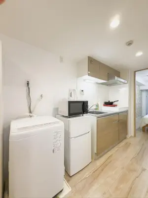 a kitchen with a refrigerator and a microwave at \u9526\u7cfb\u753a hotel -SM0380 in Tokyo