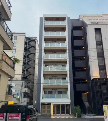 a tall apartment building with cars parked in front of it at \u9526\u7cfb\u753a hotel -SM0380 in Tokyo