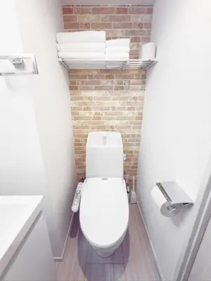 a bathroom with a toilet and a brick wall at \u9526\u7cfb\u753a hotel -SM0380 in Tokyo