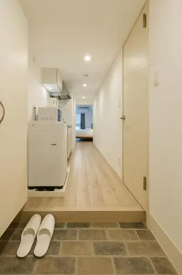 a hallway with two white slippers on the floor at \u9526\u7cfb\u753a hotel -SM0380 in Tokyo