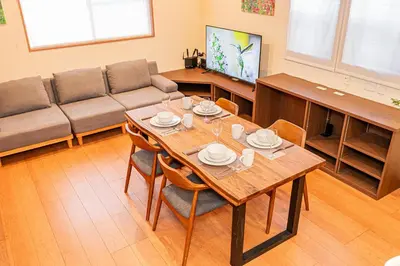 a living room with a wooden table and a couch at Mori Hotel \u9280\u5ea7 in Tokyo