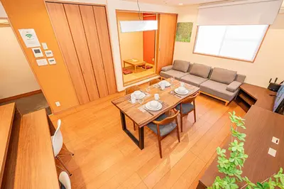 a living room with a table and a couch at Mori Hotel \u9280\u5ea7 in Tokyo