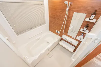 a bathroom with a bath tub and a window at Mori Hotel \u9280\u5ea7 in Tokyo
