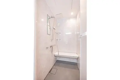 a bathroom with a shower and a toilet in it at Mori Hotel \u9280\u5ea7 in Tokyo
