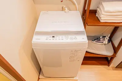 a washer and dryer sitting in a closet at Mori Hotel \u9280\u5ea7 in Tokyo