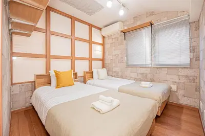 two beds in a room with two windows at Mori Hotel \u9280\u5ea7 in Tokyo