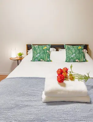 a bed with a white blanket and flowers on it at \u6d45\u8349 ideas hotel \u5927\u5e8a\u623f-TT0390 in Tokyo