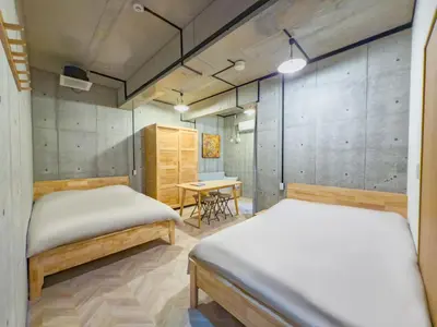two beds in a room with a table and a desk at \u6d45\u8349 ideas hotel max 6 people -TT0392 in Tokyo