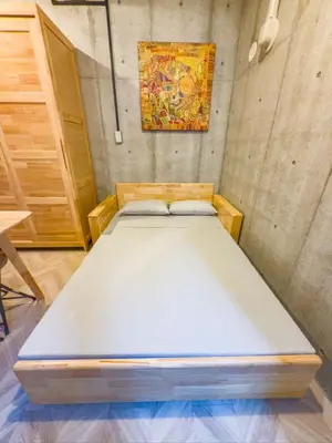 a bed in a room with a painting on the wall at \u6d45\u8349 ideas hotel max 6 people -TT0392 in Tokyo
