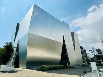 a large glass building in a city at #202 Tokyo Ryogoku Hokusai Katsushika in Tokyo