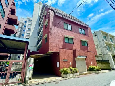 a red brick building on the side of a street at #202 Tokyo Ryogoku Hokusai Katsushika in Tokyo