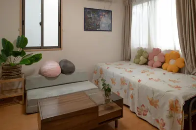 a room with a bed and a table and a window at \u30e1\u30be\u30f3\u67cf\u6728 in Tokyo