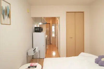 a small kitchen with a refrigerator and a room at \u30e1\u30be\u30f3\u67cf\u6728 in Tokyo