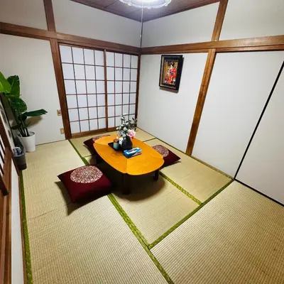 a room with a table and chairs in a room at Asakusa Ginza direct access to the airport in Tokyo
