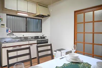 a kitchen with a table and a stove top oven at Asakusa Ginza direct access to the airport in Tokyo
