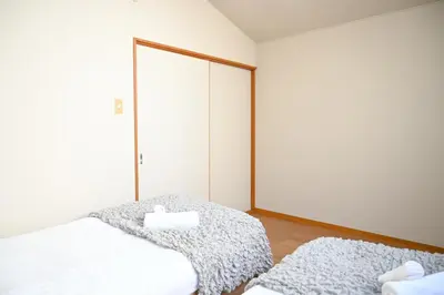 a bedroom with two beds and a large mirror at Asakusa Ginza direct access to the airport in Tokyo