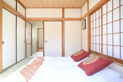 a bedroom with a bed with red pillows at Asakusa Ginza direct access to the airport in Tokyo