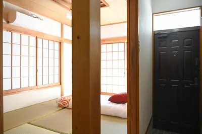 a room with a door and a bed in it at Asakusa Ginza direct access to the airport in Tokyo