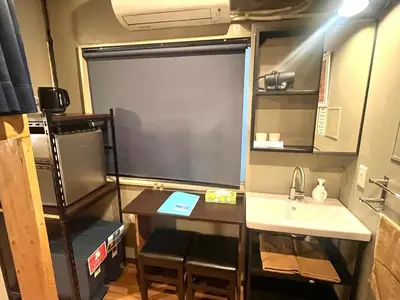 a small kitchen with a table and a sink at Wasabi Mita Hotel - Vacation STAY 29125v in Tokyo