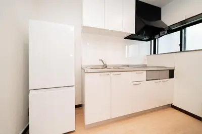 a kitchen with white cabinets and a sink at GLOU Shibuya House - A Private House in Tokyo Shinjuku & Shibuya Area in Tokyo
